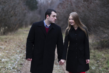 young couple walking in falling park