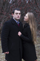 young attractive woman looking to man in park