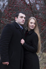 young couple looking to somewhere in falling park