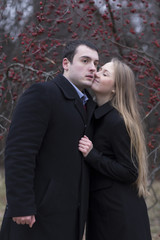 young couple kissing in falling park