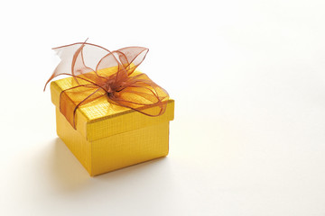 Golden gift box with brown tie