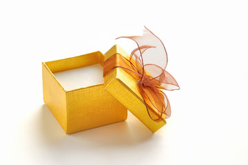 Open golden gift box with brown tie