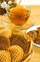 cup of tea and cookies on the saucer closeup