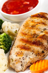 Grilled chicken breast fillet with stew vegetables and sauce