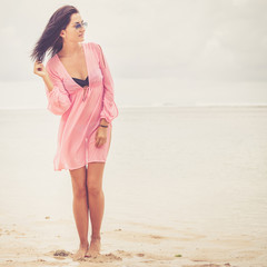 portrait of a beautiful brunette girl on the beach