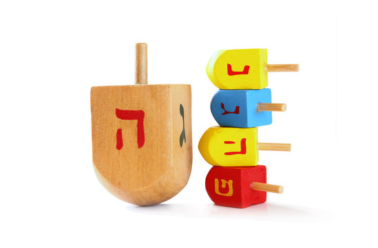 wooden colorful dreidels (spinning top) for hanukkah jewish holiday isolated on white
