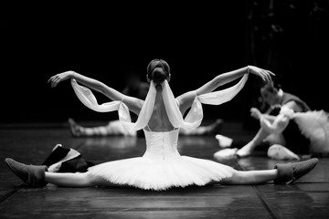 Gorgeous ballerina repeating movements backstage