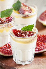 Creamy white yogurt with honey, figs and mint, selective focus
