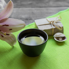 Asian tea cup and spa settings on wooden board