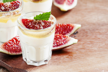 Creamy white yogurt with honey, figs and mint, selective focus