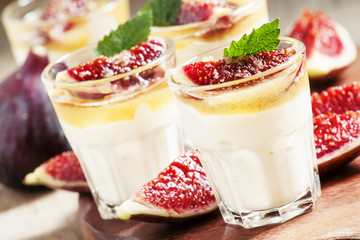 Creamy white yogurt with honey, figs and mint, selective focus