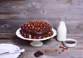 Delicious chocolate cakes with hazelnut on table and dark chocol