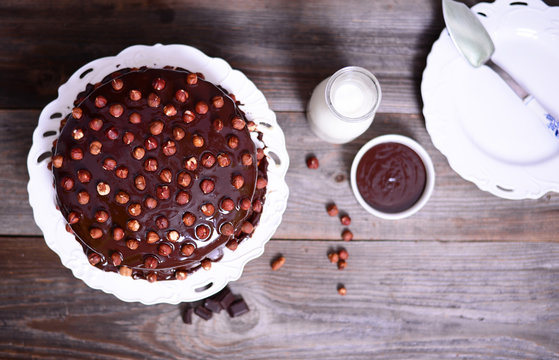 Hazelnut-chocolate cake on wooden background