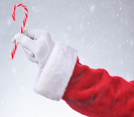 Santa Hanging Candy Cane Snowy Background
