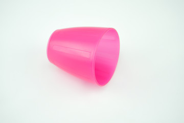 pink plastic mug on white background