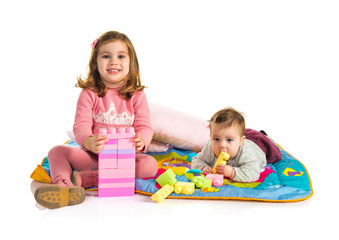 Sisters playing over white background