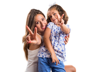 Fototapeta na wymiar Mother and daughter doing victory gesture