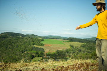 Fototapeta premium Farmer Spreading Seeds