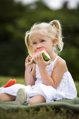 portrait of a little girl eating watermelon