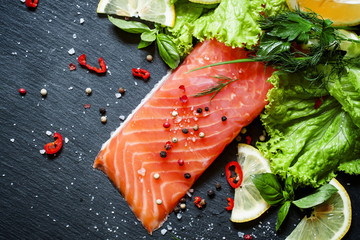 Tasty piece of salmon fillet with herbs, spices, lemon, salt, pe