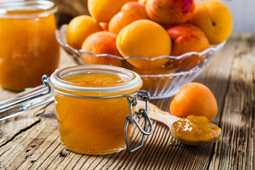 Homemade organic apricot jam in glass jar and ripe apricots
