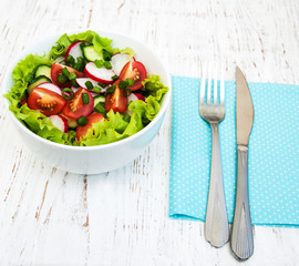 Spring salad with tomato, cucumbers and radish