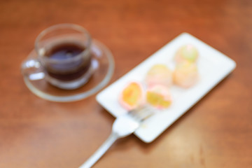 Obraz na płótnie Canvas Blur Chinese pastry and black coffee on wood plane