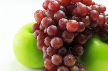 Apple and grapes on white background