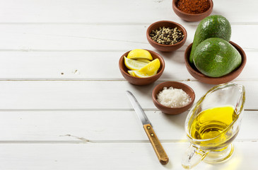 Avocado, and other ingredients for sauce guacamole on the table.