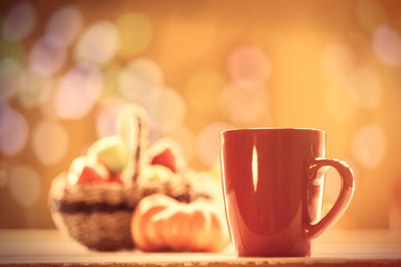 Pumpkin, basket with apples and cup