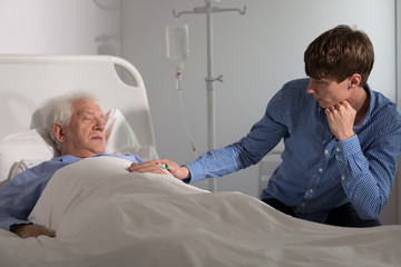 Son watching over his father