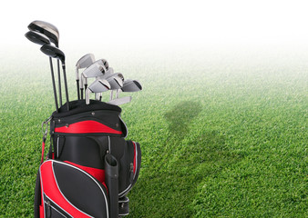 Golf clubs in front of faded tee box grass