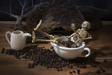 Still life with skull and death. Skeleton with coffee beans