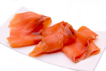 Smoked salmon on small tray on a white background seen close