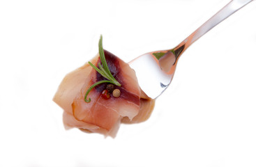 Smoked swordfish on fork on white background seen from above