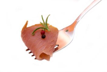 Smoked tuna on fork on white background
