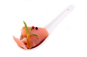 Smoked tuna on teaspoon on white background