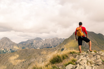 Hiking man or trail runner in mountains