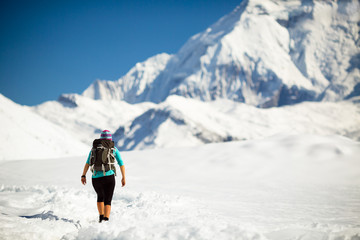 Fototapeta na wymiar Woman walking in winter mountains