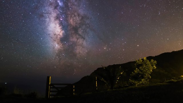 The Milky Way panning over the Island of Sao Miguel, Azores. Distant lights come from the island Santa Maria, more that 100 miles away.