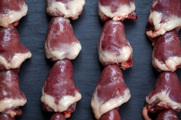 Ready to cook Close up Duck Heart stringed on skewers BBQ.  background