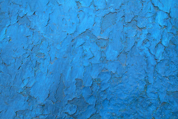 Background image of an old wall with blue paint peeling off.