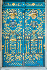 Blue door decorated with golden adornment