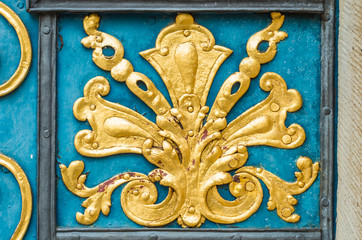 Blue door decorated with golden adornment