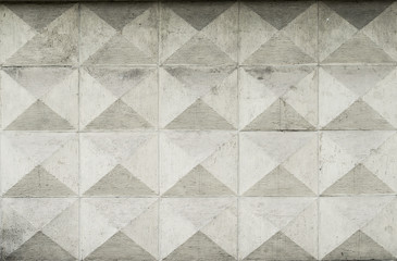 Old ashlar wall made of dolomite rock carved in geometrical pattern