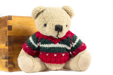 Teddy bear with red wool coat, on white