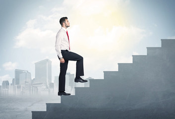 Businessman climbing up a concrete staircase concept