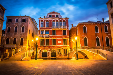 Narrow canal in Venice in the evening