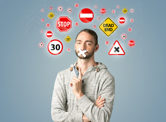 Young man with glued mouth and traffic signals