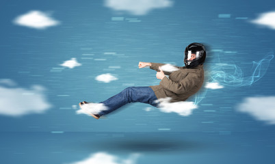 Funny racedriver young man driving between clouds concept